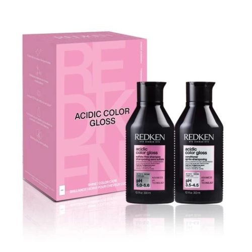 Coffret REDKEN Acidic Color Gloss avec shampoing et revitalisant 300 ml, bouteilles noires étiquette rose et boîte rose, présenté sur fond blanc.