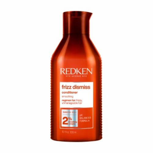 Bouteille orange REDKEN Frizz Dismiss après-shampoing lissant 300 ml avec bouchon flip-top, soin anti-frisottis pour cheveux secs et indisciplinés, fond blanc professionnel.