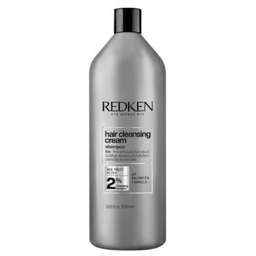 Bouteille REDKEN Hair Cleansing Cream shampoing clarifiant 1000 ml grise avec bouchon noir pour purification en profondeur sur fond blanc.