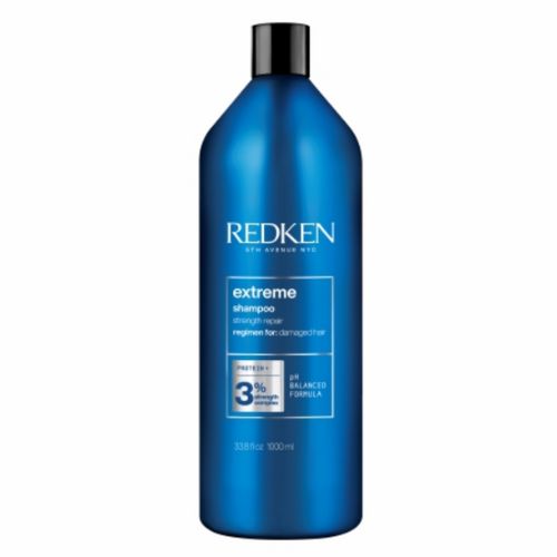 Shampooing Redken Extreme format 1 litre en grande bouteille bleue, soin fortifiant professionnel pour cheveux abîmés aux protéines, format salon sur fond blanc.