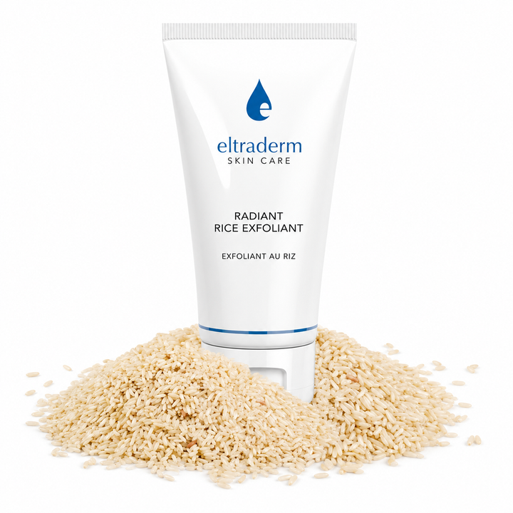 Tube Eltraderm Exfoliant Radiant au Riz posé sur un lit de grains de riz sur fond blanc. Soin exfoliant visage au son de riz, conçu pour lisser la peau et révéler un teint plus lumineux.
