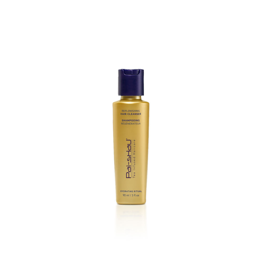 Shampoing régénérateur Pai-Shau format voyage 90 ml – flacon doré mat avec bouchon violet, étiquette verticale violette, sur fond blanc professionnel. Soin capillaire hydratant végétalien infusé au thé, idéal pour cheveux secs ou ternes.